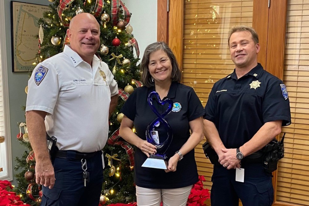 Photo of three Indian Creek employees accepting the award on the recipient's behalf