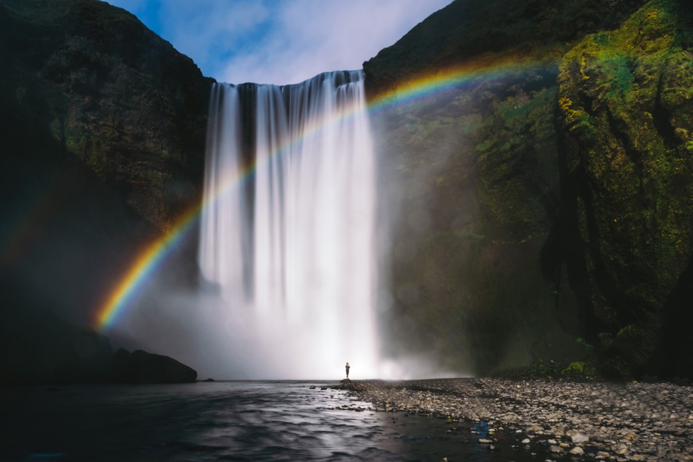 Rainbow in front of waterfall