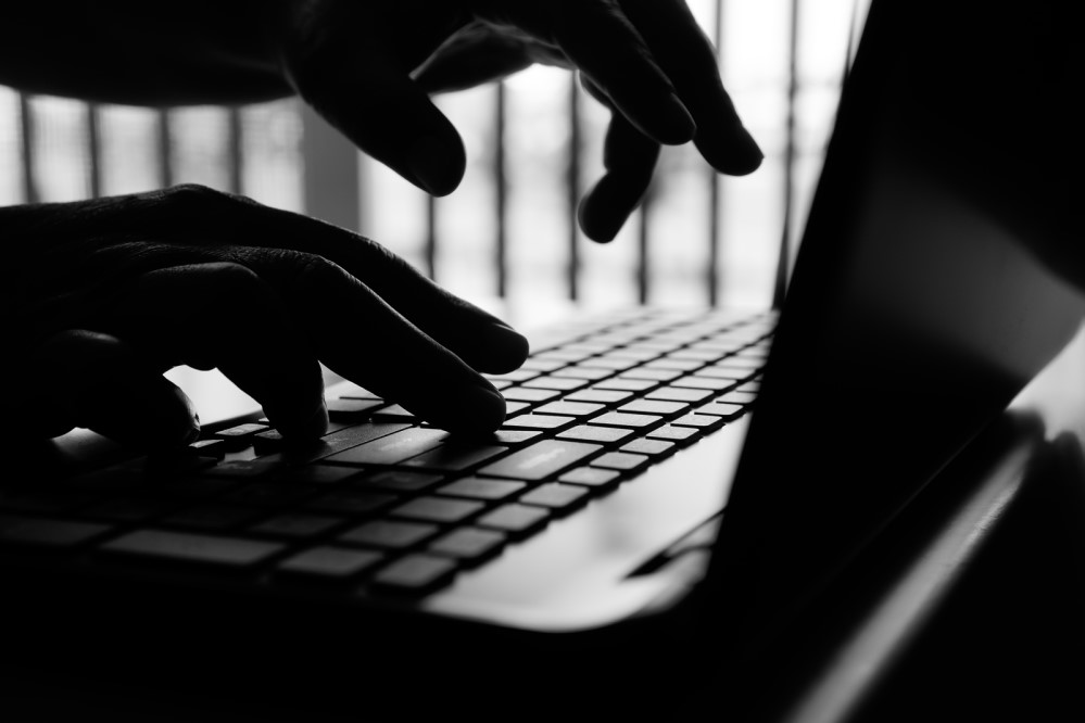 Photo of hands typing on a laptop