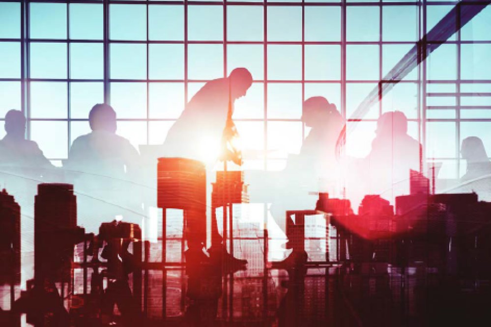 Silhouette of people working together in an office