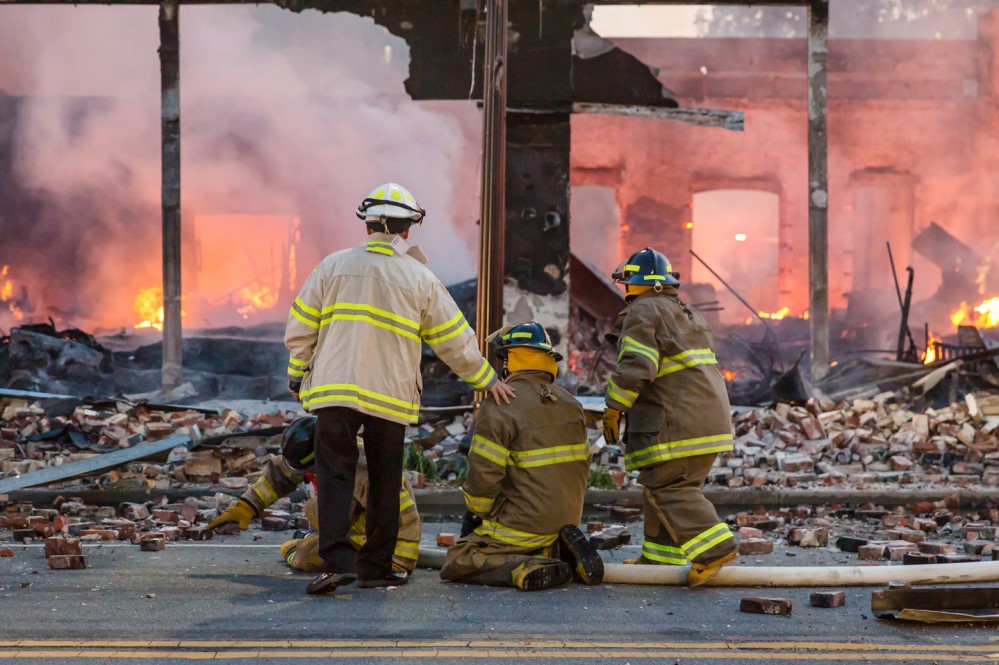 Image of firefighters in front of fire