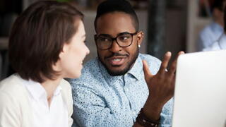 Image of two people chatting 