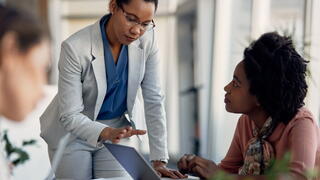 An image of people having a discussion in an office