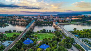 Image of bridges over a river amidst a city skyline