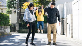 Photo of family playing together on a city street